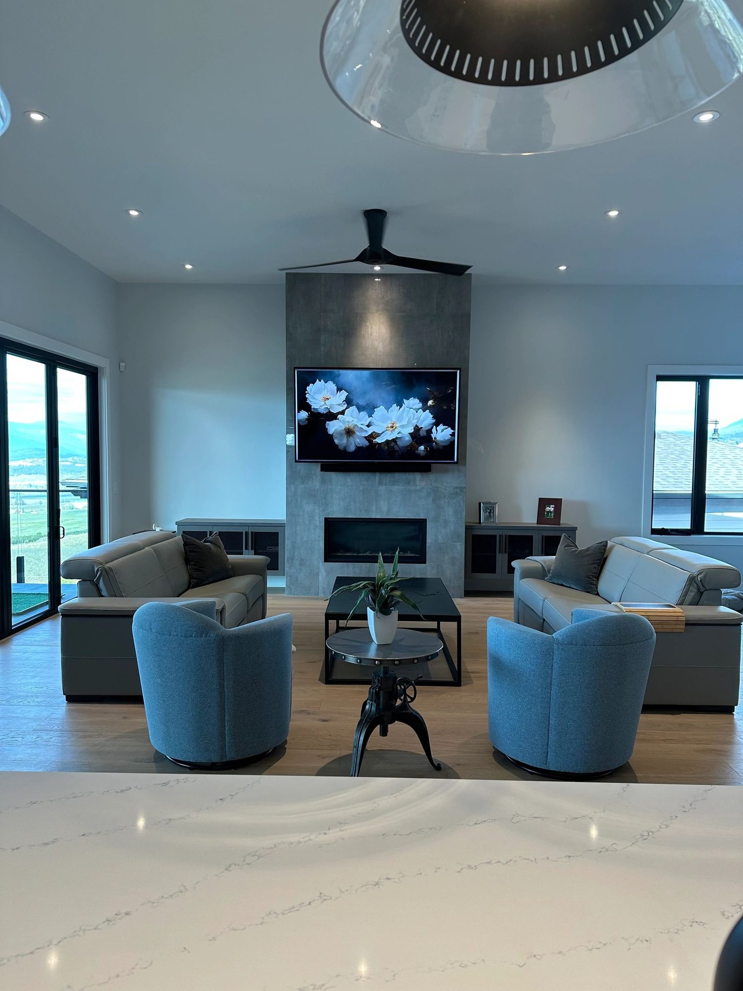 Lakeview living room in Kelowna with a TV mounted above the fireplace