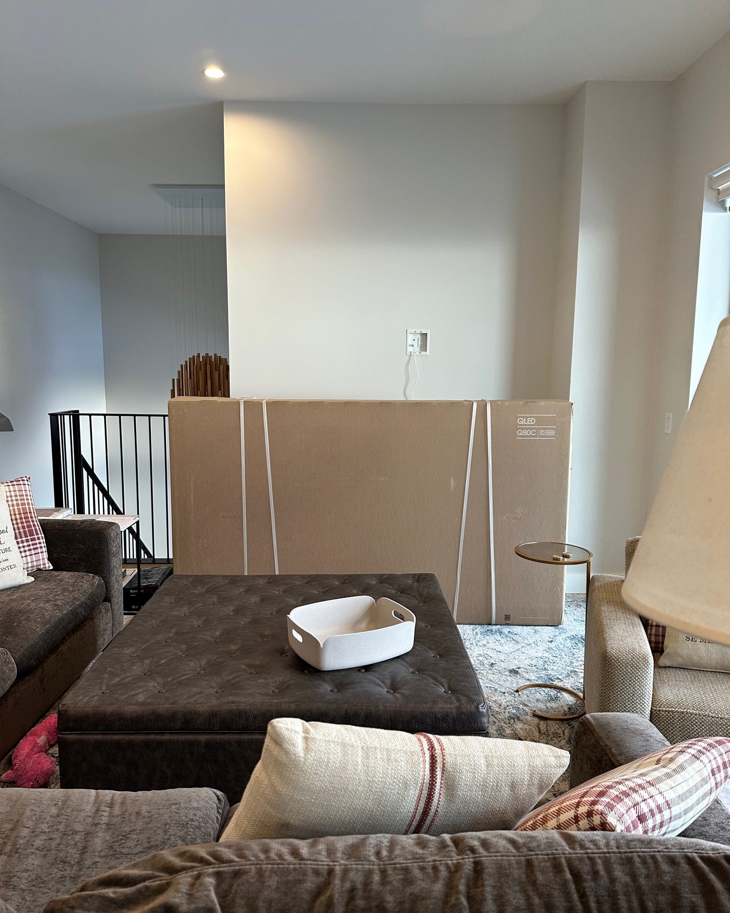 Blank alcove wall with the new 85 inch TV still boxed on the floor