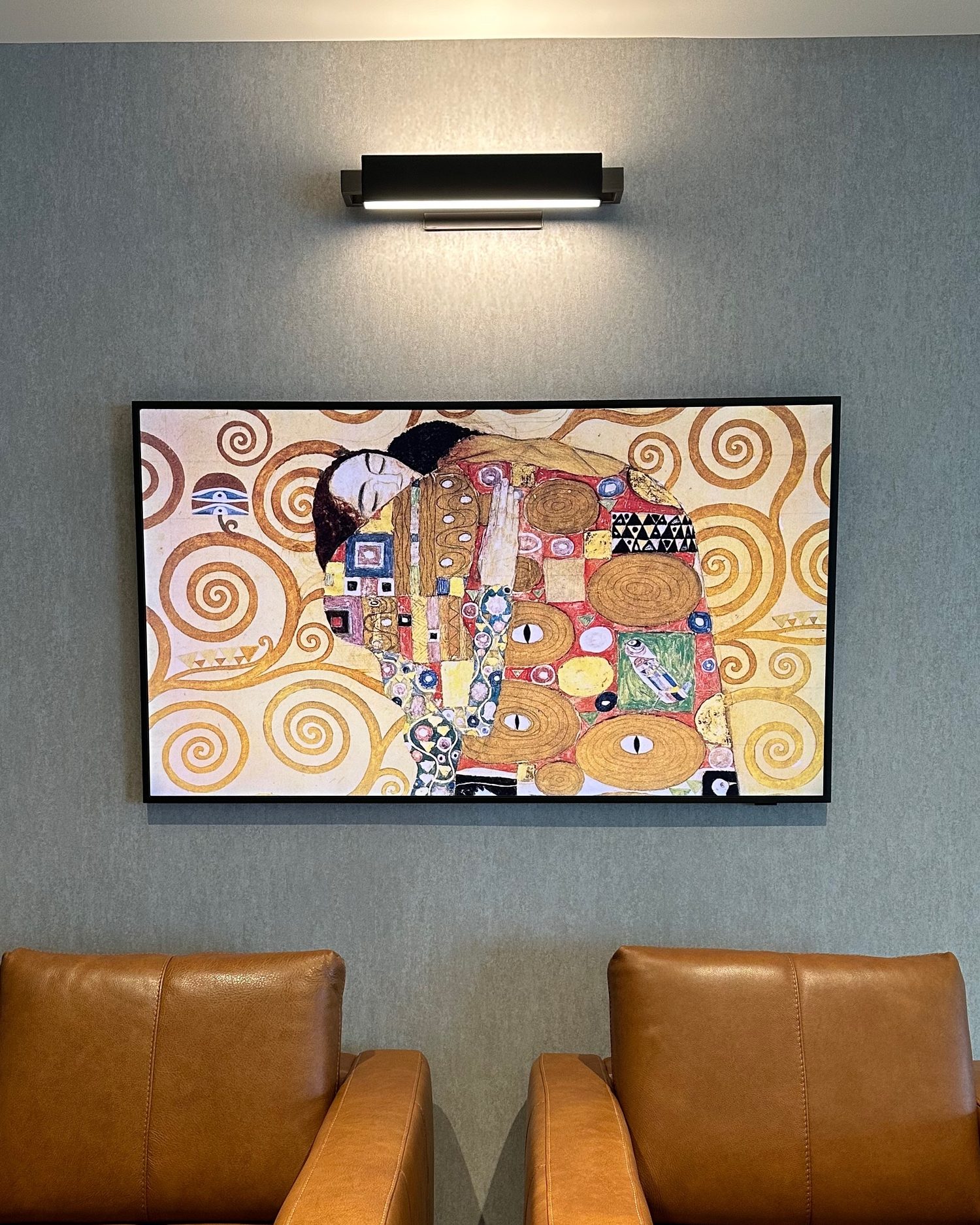 TV mounted flush on the lounge wall in art mode with every cable concealed